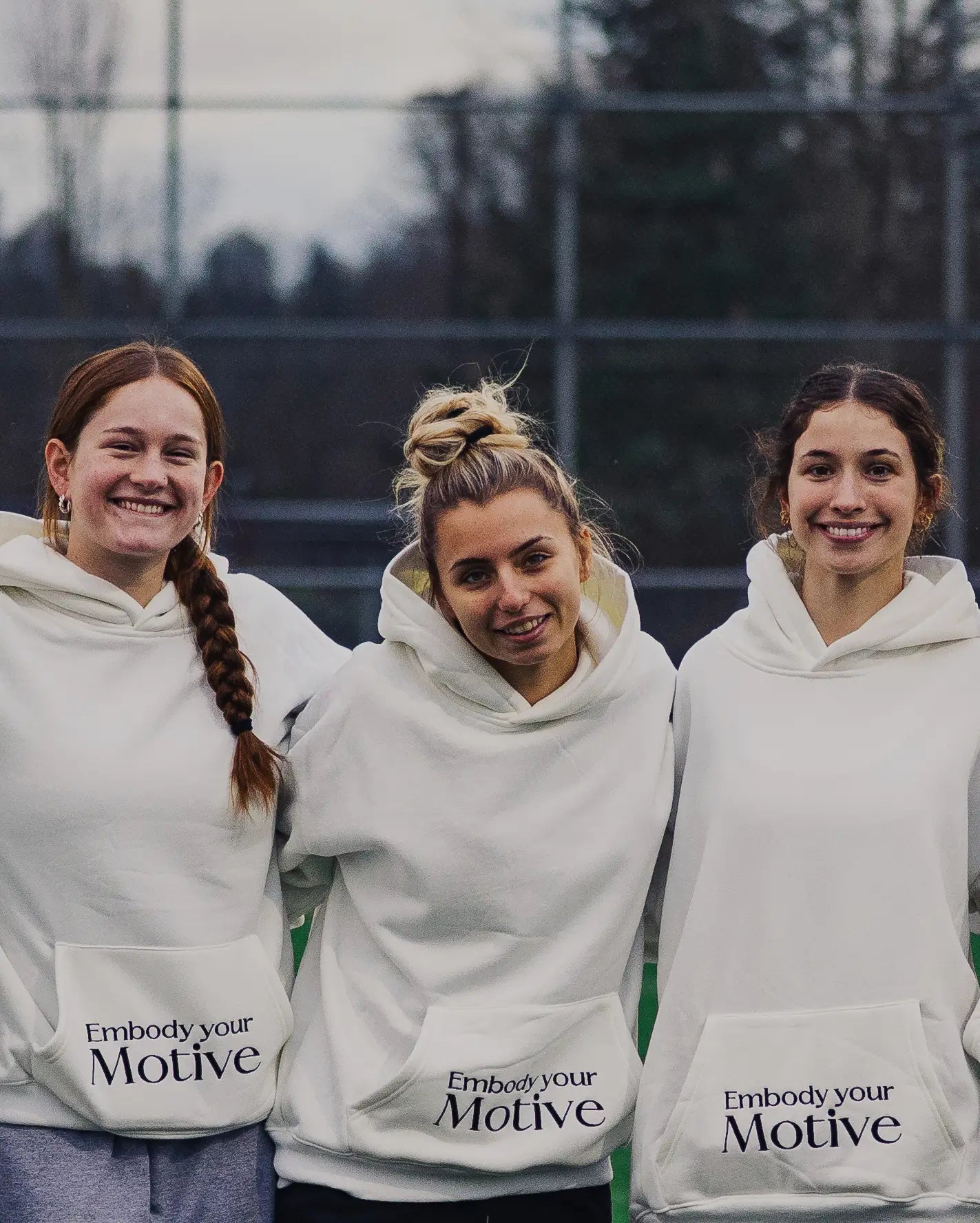 Womens lacrosse players wearing Motive Athletics hoodies
